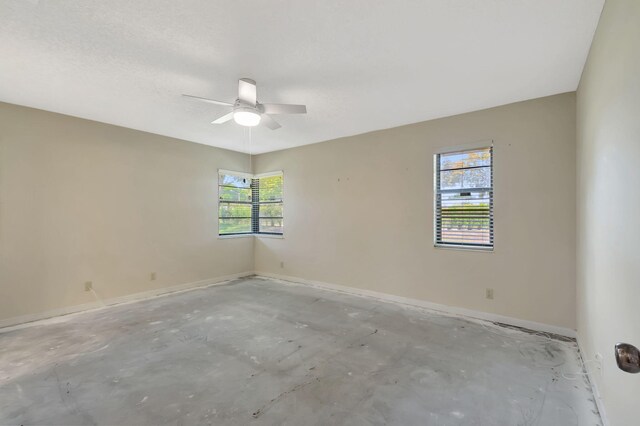 8449 Springlake Dr, Boca Raton, FL 33496 - unfurnished bedroom featuring unfinished concrete floors, baseboards, a ceiling fan, and a textured ceiling