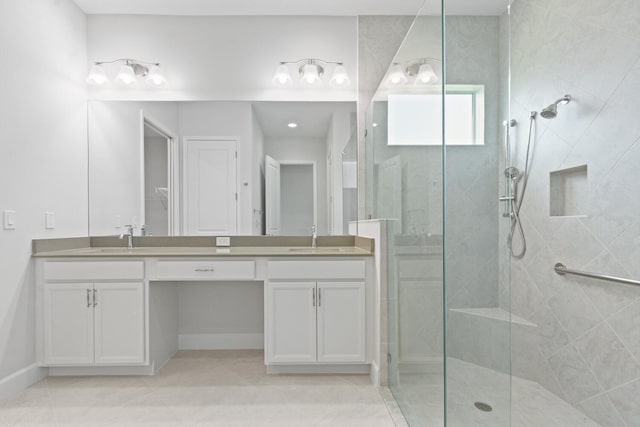full bathroom with a sink, tile patterned floors, and tiled shower