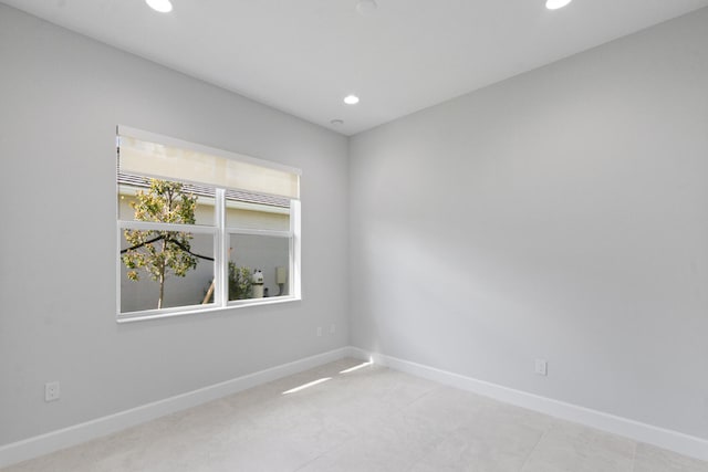 empty room with baseboards and recessed lighting