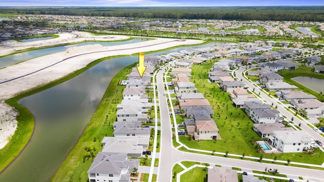 birds eye view of property featuring a water view and a residential view
