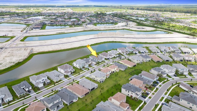 drone / aerial view featuring a water view and a residential view