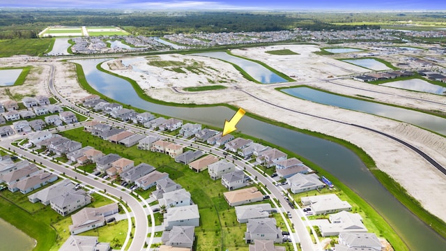 drone / aerial view featuring a residential view and a water view