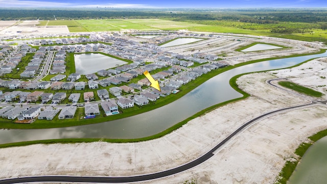 birds eye view of property with a water view and a residential view