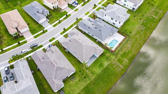 bird's eye view featuring a water view and a residential view