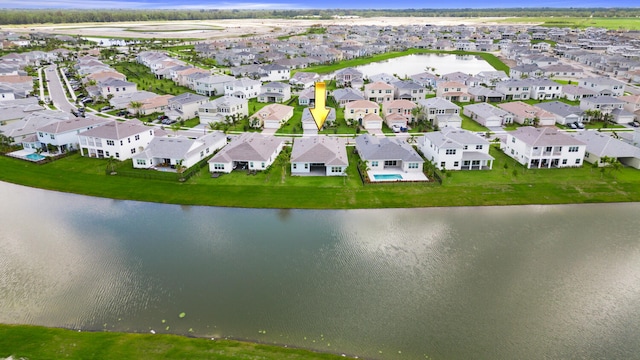 drone / aerial view featuring a water view and a residential view