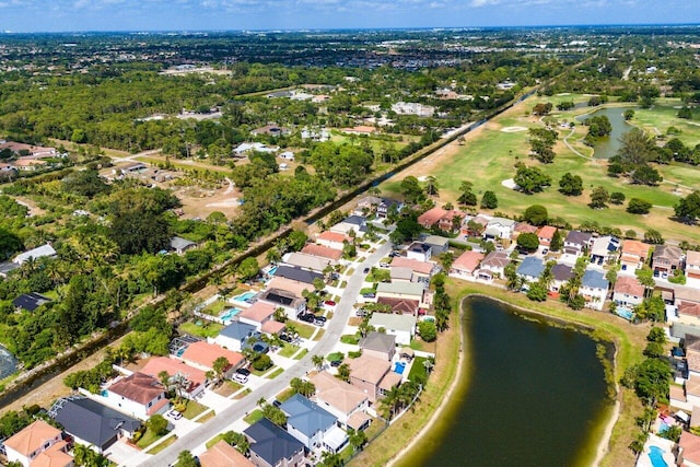 aerial view with a residential view, a water view, and golf course view