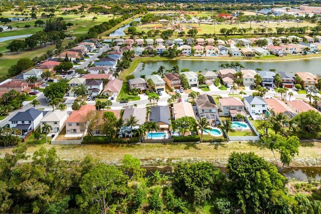 bird's eye view with a water view, view of golf course, and a residential view