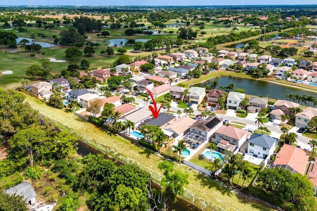 birds eye view of property with a water view, a residential view, and golf course view