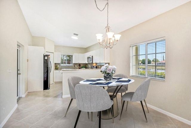 dining area featuring an inviting chandelier, baseboards, and light tile patterned floors