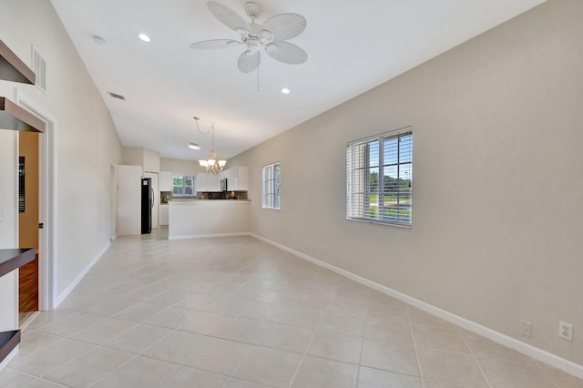 unfurnished room featuring visible vents, recessed lighting, ceiling fan with notable chandelier, and light tile patterned flooring