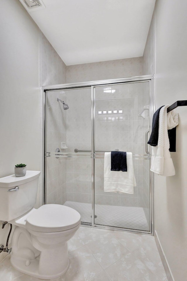 full bathroom featuring tile patterned flooring, a shower stall, toilet, and visible vents