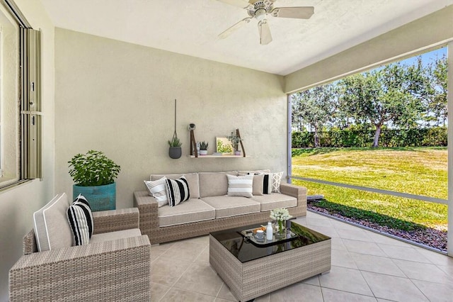 sunroom with plenty of natural light, a ceiling fan, and outdoor lounge area