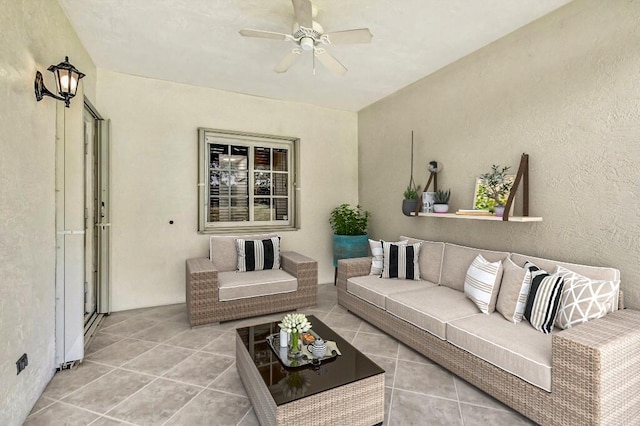 tiled living room featuring ceiling fan