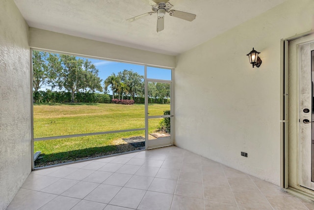 unfurnished sunroom with ceiling fan