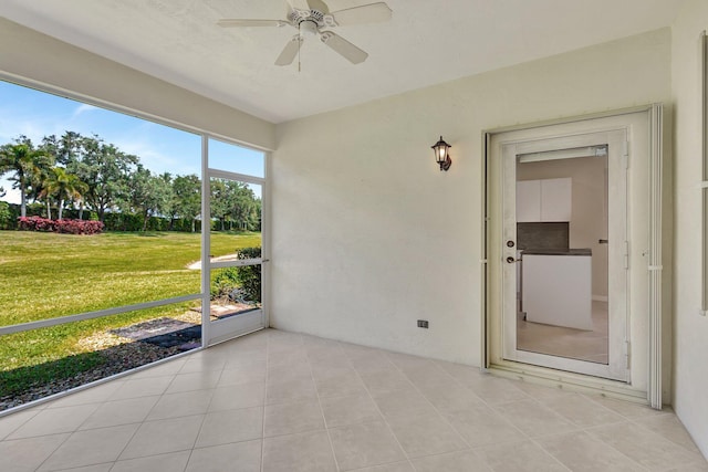 unfurnished sunroom featuring ceiling fan