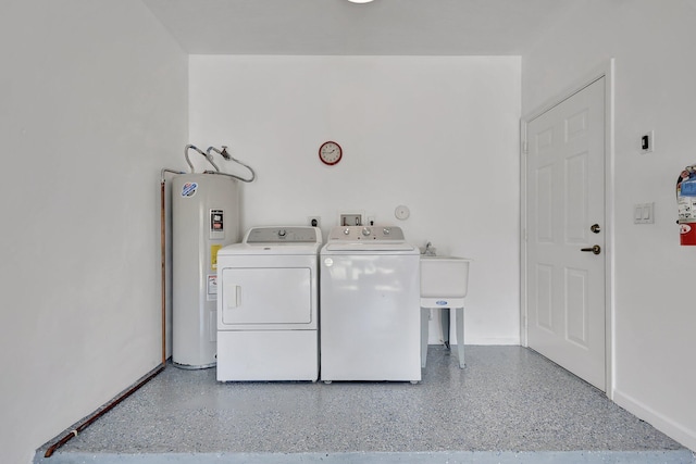 washroom with baseboards, laundry area, independent washer and dryer, and electric water heater
