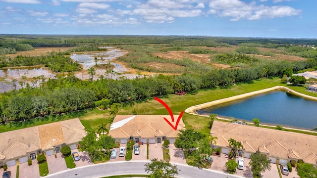 drone / aerial view with a residential view and a water view