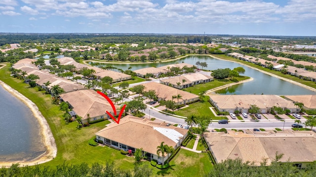 drone / aerial view with a water view and a residential view