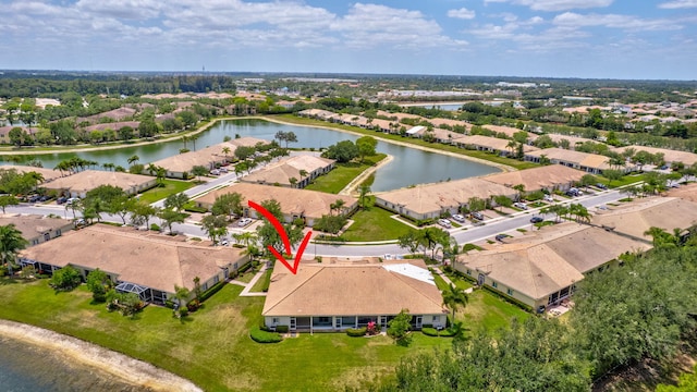 drone / aerial view featuring a water view and a residential view