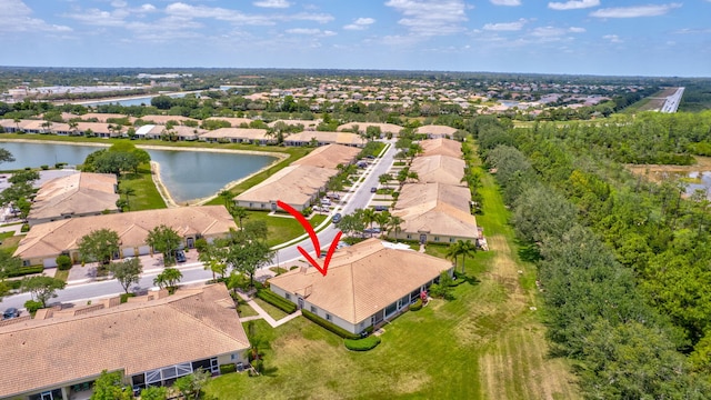 drone / aerial view with a water view and a residential view