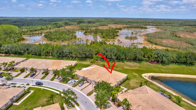 bird's eye view with a water view and a view of trees