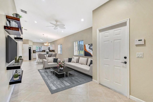 living area featuring visible vents, baseboards, recessed lighting, ceiling fan with notable chandelier, and light tile patterned floors