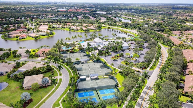 drone / aerial view featuring a residential view and a water view