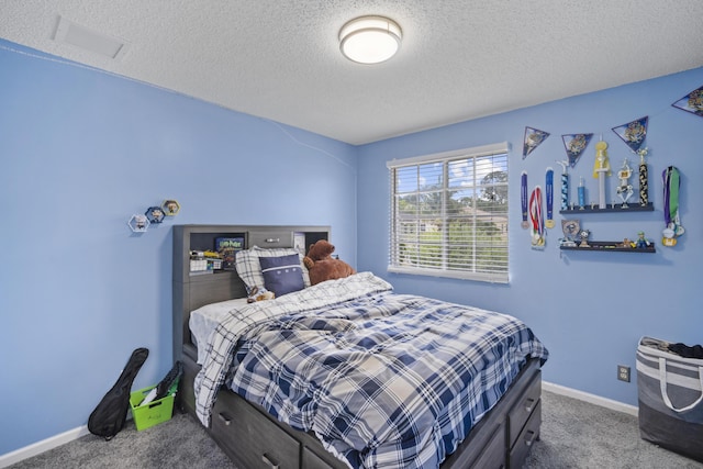 bedroom with carpet flooring, a textured ceiling, visible vents, and baseboards