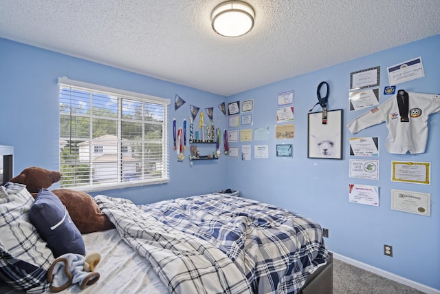 bedroom featuring carpet floors, a textured ceiling, and baseboards