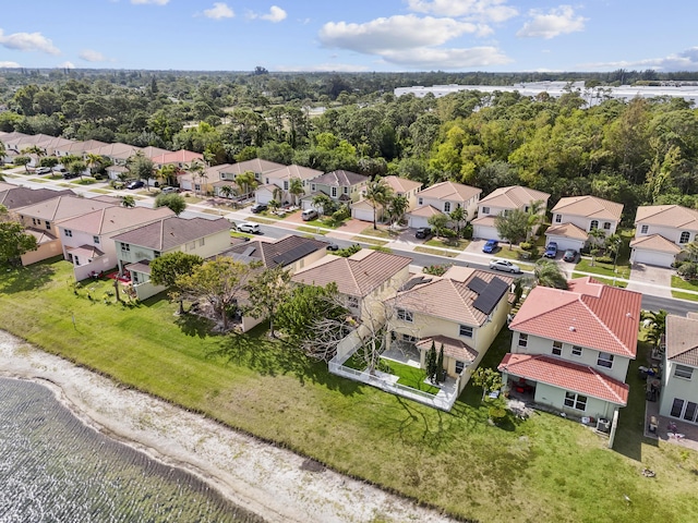 drone / aerial view with a water view and a residential view