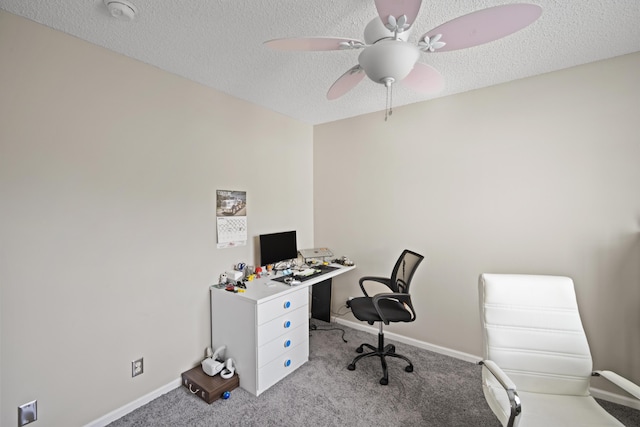 office area with a textured ceiling, light carpet, and baseboards