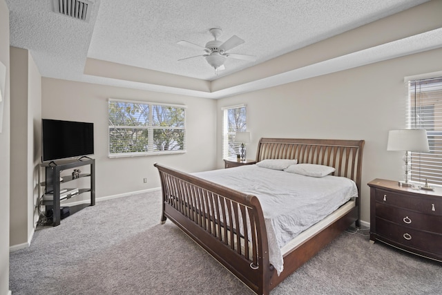 bedroom with a textured ceiling, carpet, a ceiling fan, baseboards, and visible vents