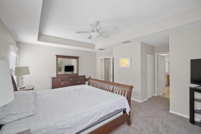 bedroom featuring carpet floors, a textured ceiling, baseboards, and visible vents