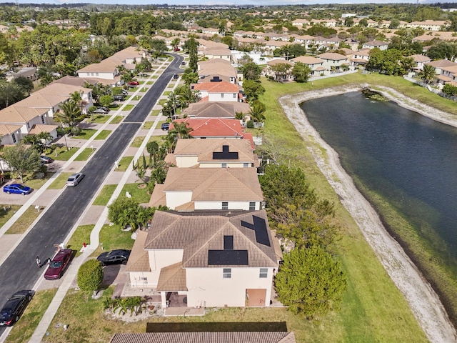 drone / aerial view featuring a water view and a residential view