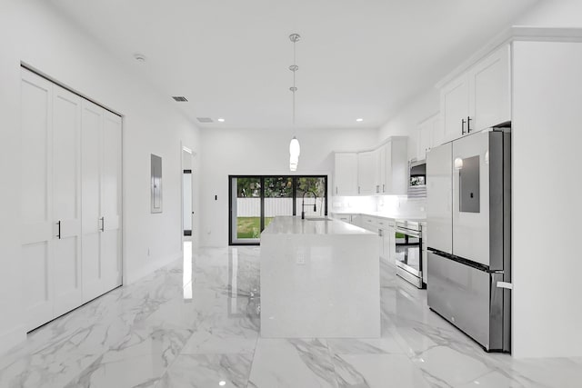 kitchen featuring pendant lighting, marble finish floor, white cabinetry, a sink, and stainless steel appliances