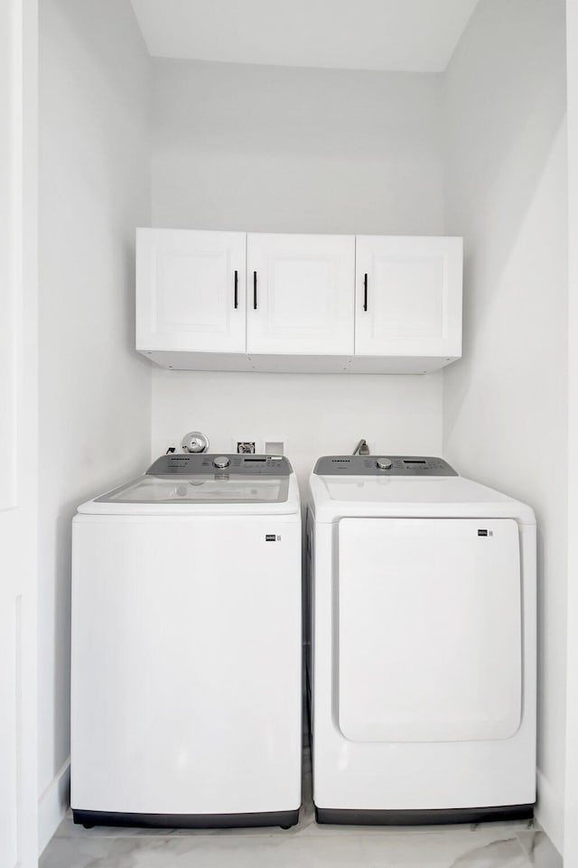 laundry room with cabinet space and washing machine and clothes dryer
