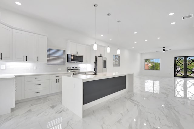 kitchen with appliances with stainless steel finishes, white cabinets, recessed lighting, and visible vents