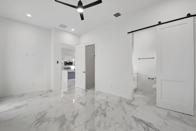 unfurnished bedroom featuring recessed lighting, marble finish floor, a barn door, and visible vents