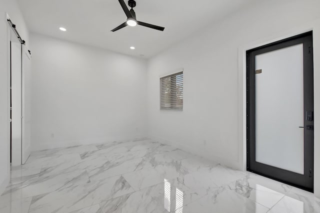 unfurnished bedroom with recessed lighting, ceiling fan, a barn door, and marble finish floor