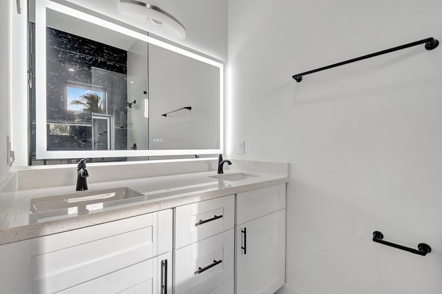 full bath with double vanity, a sink, and a shower
