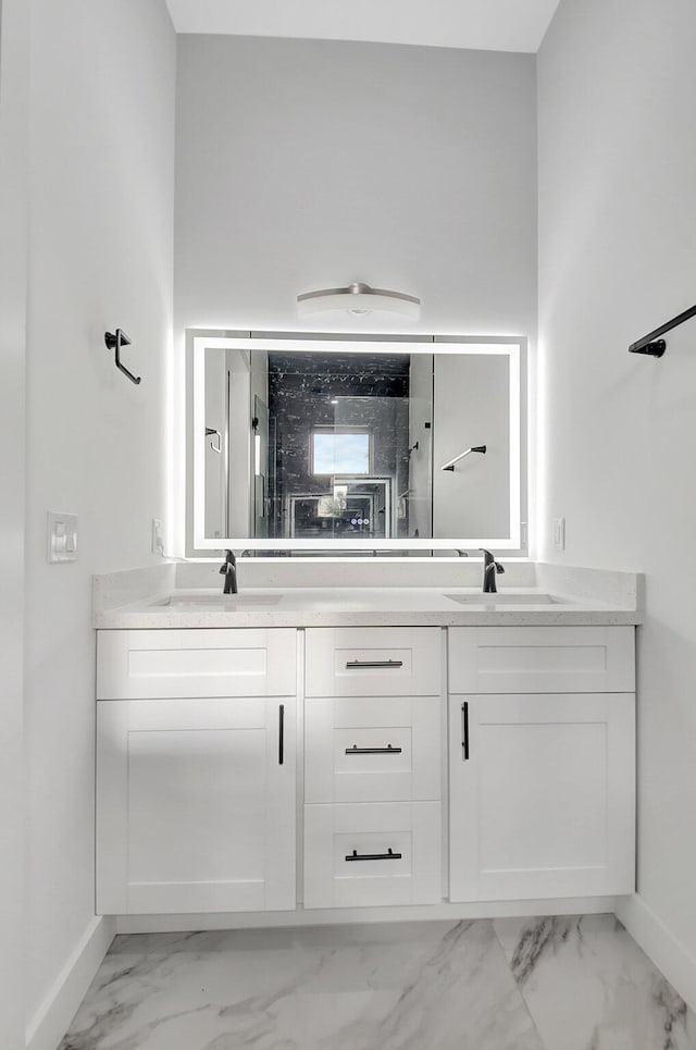 full bathroom featuring double vanity, a sink, and marble finish floor