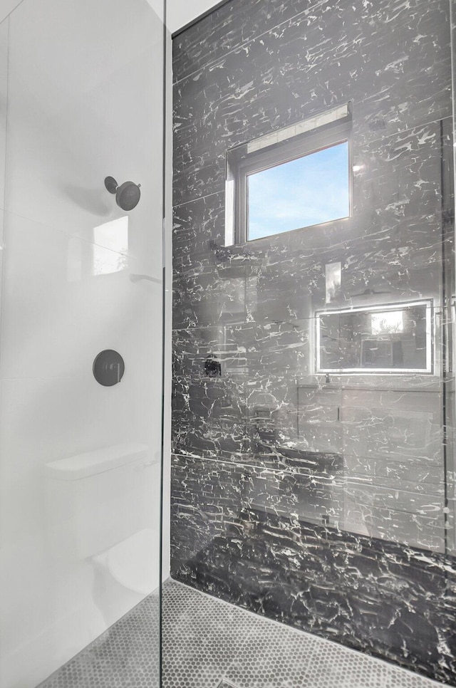 full bath featuring tile patterned floors and a tile shower