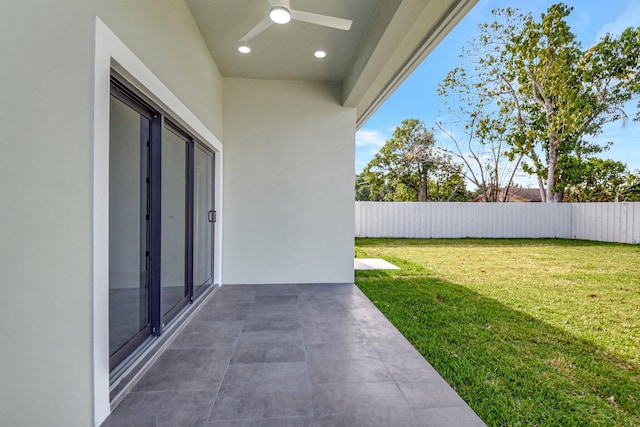 view of yard with a patio, a ceiling fan, and a fenced backyard