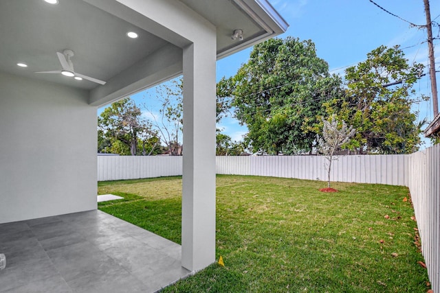 view of yard featuring a patio, a ceiling fan, and a fenced backyard