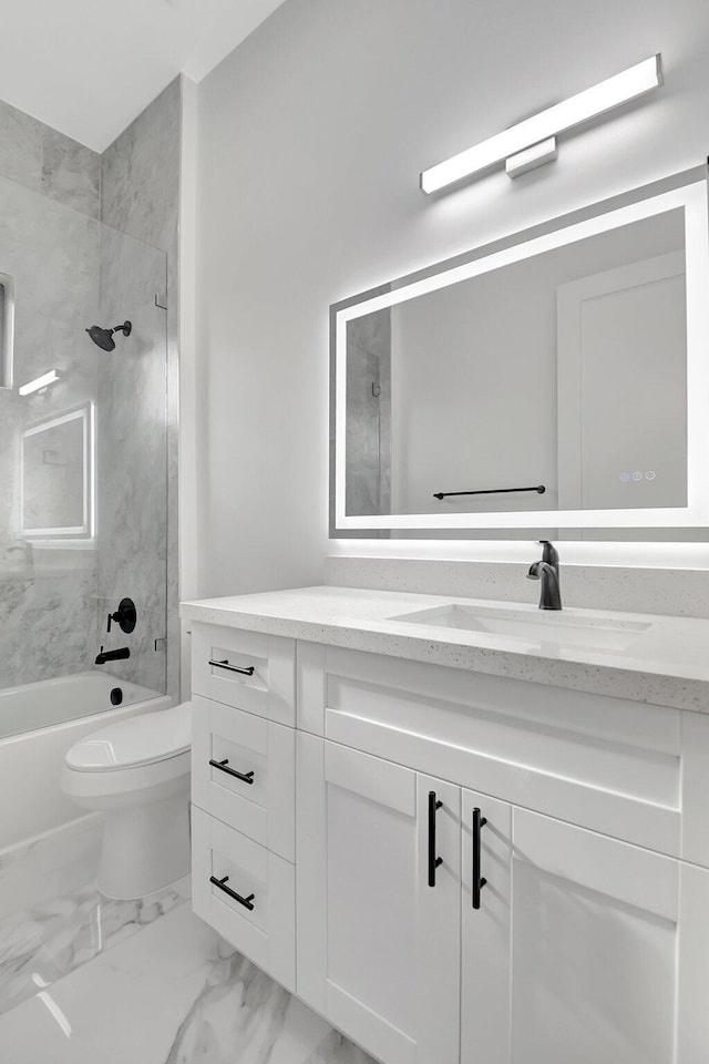 bathroom featuring vanity, marble finish floor, shower / bathtub combination, and toilet
