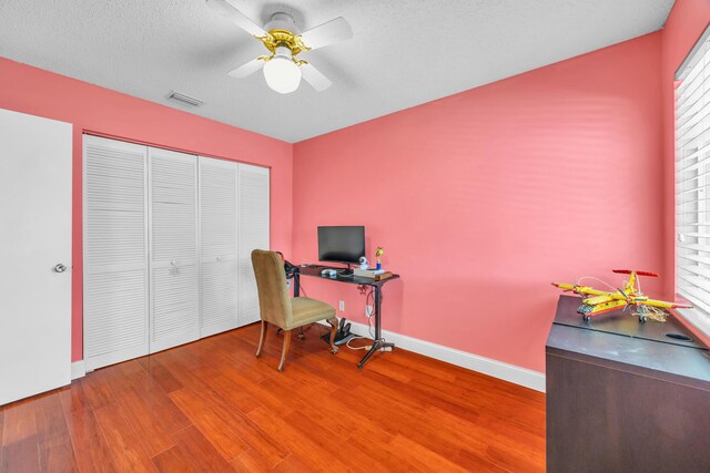 office with plenty of natural light, a ceiling fan, baseboards, and wood finished floors