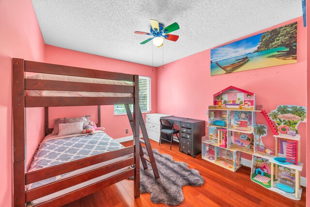 bedroom featuring a ceiling fan, a textured ceiling, and wood finished floors