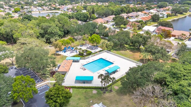 drone / aerial view with a water view and a residential view
