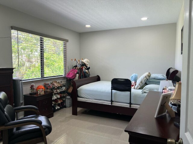 bedroom featuring recessed lighting and a textured ceiling