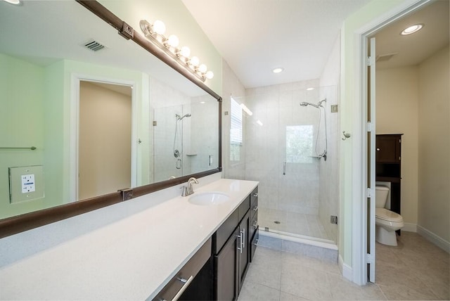 bathroom with tile patterned floors, toilet, a stall shower, and recessed lighting